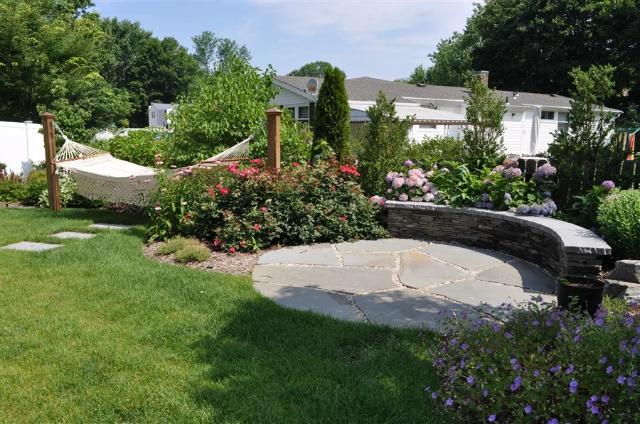 landscaped garden with trees and plants and a hammock