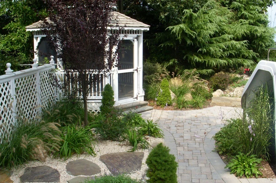 patio and gazebo with surrounding trees and plants