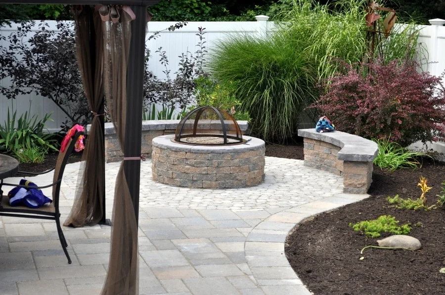 pavers patio and firepit with surrounding plants