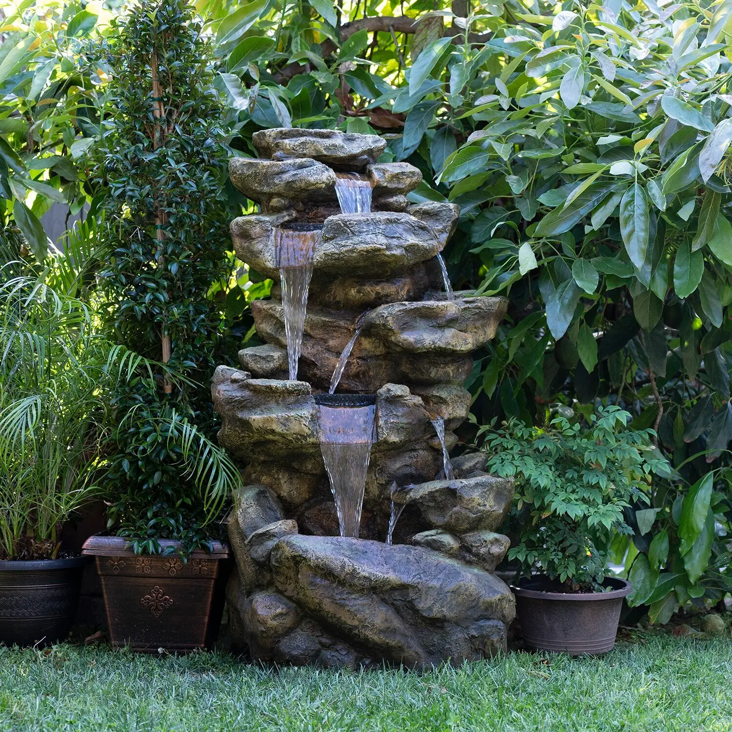 stone fountain surrounded by plants